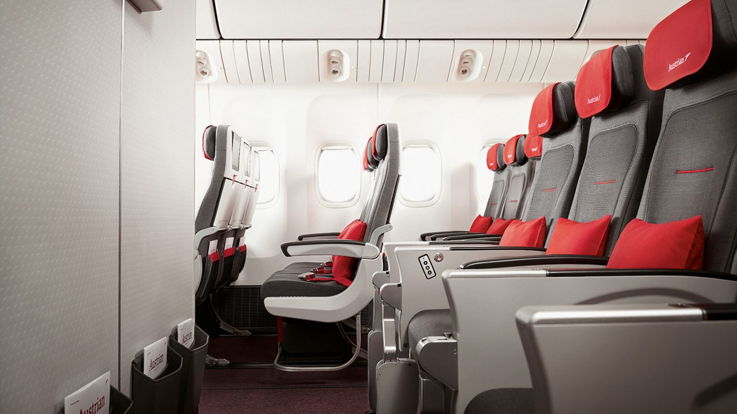 Austrian aircraft seats in the middle row with red cushions