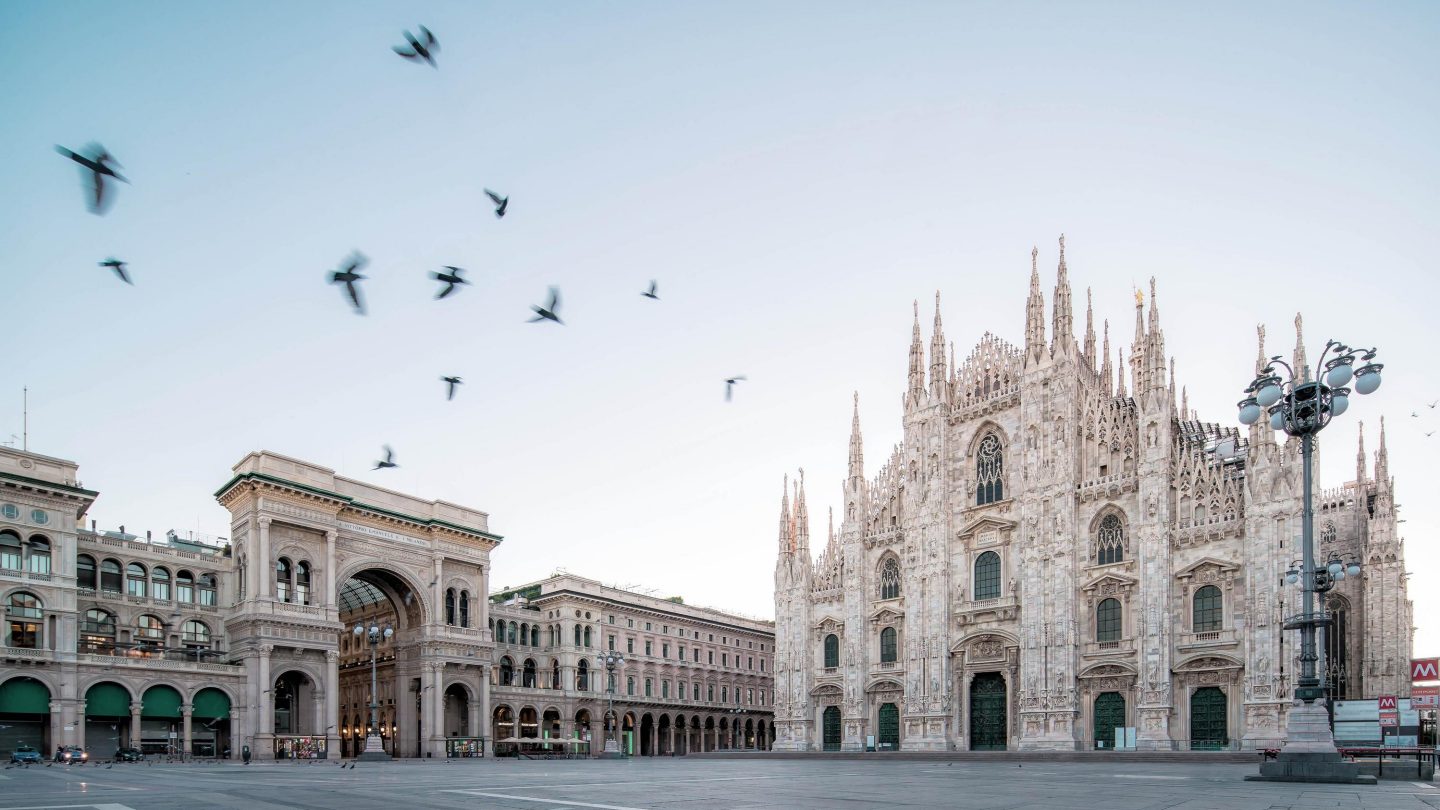 Galleeria Vittorio Emenuele and Milan Cathedral square with flying pegion in the morning