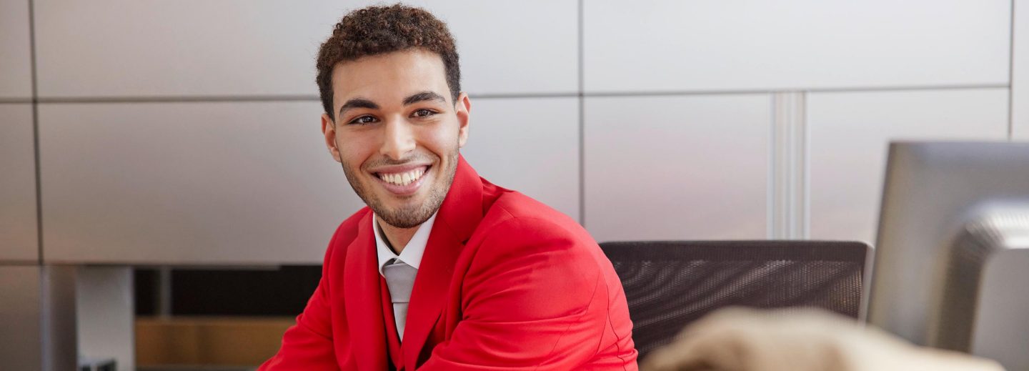 Smiling man in airline uniform.