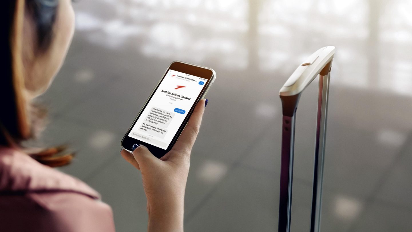 Asian tourist woman hands holding and using smartphone with blank screen waiting for flight in airport lounge.