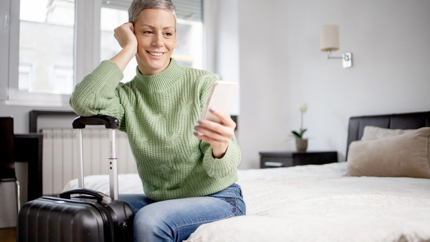 Woman traveler prepare things into suitcase