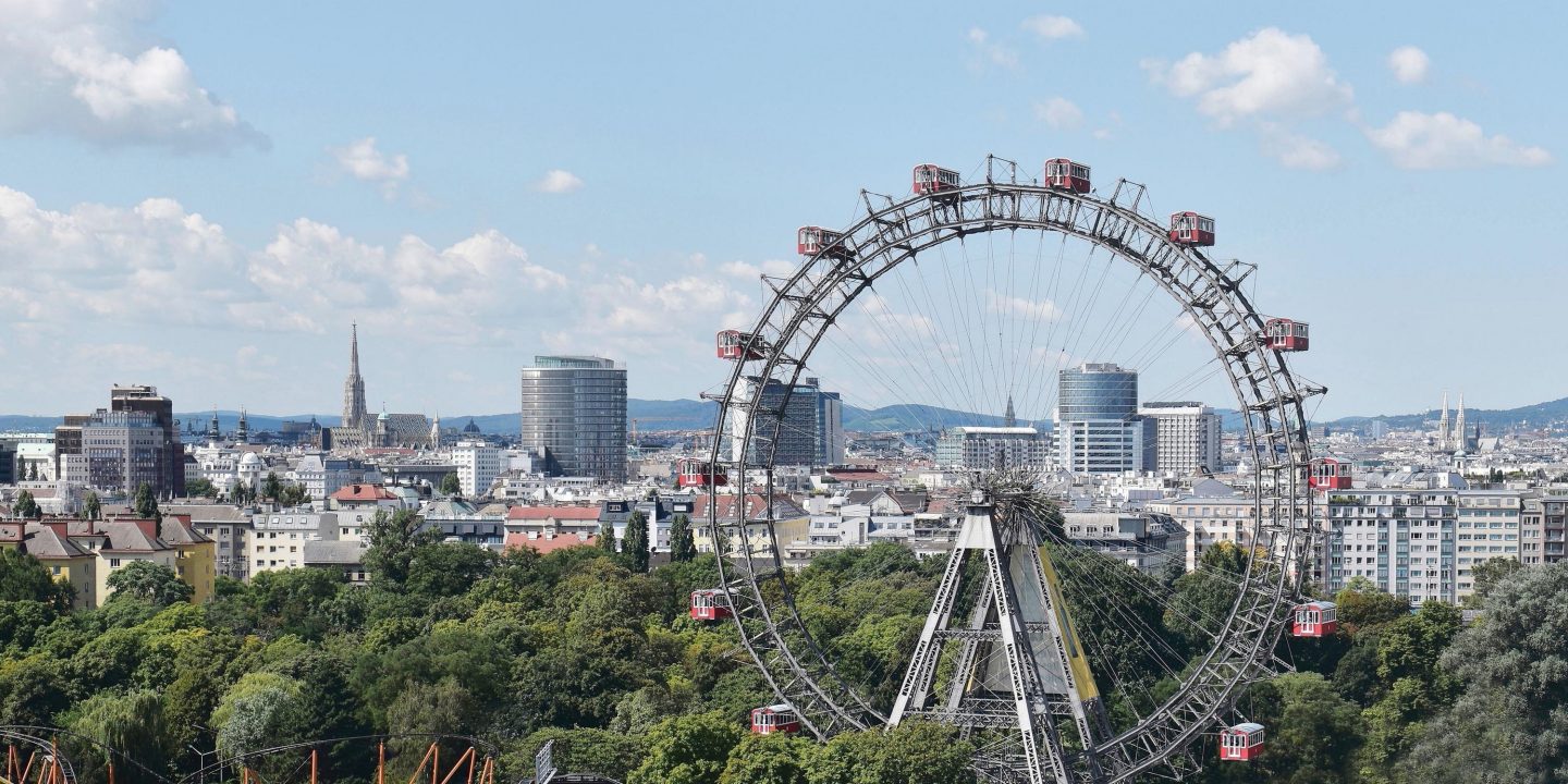 Panoramic view of Vienna, capital city of Austria, Europe. Ferris Wheel in Prater Entertainment Park, St. Stephen's Cathedral in the background