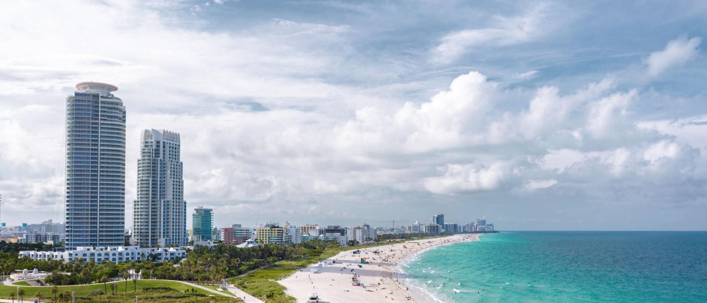 Panoramic view of South Beach at Miami South Pointe Park with high skyscrapers and a blue sunny summer sky, Florida, USA on a cruise day.