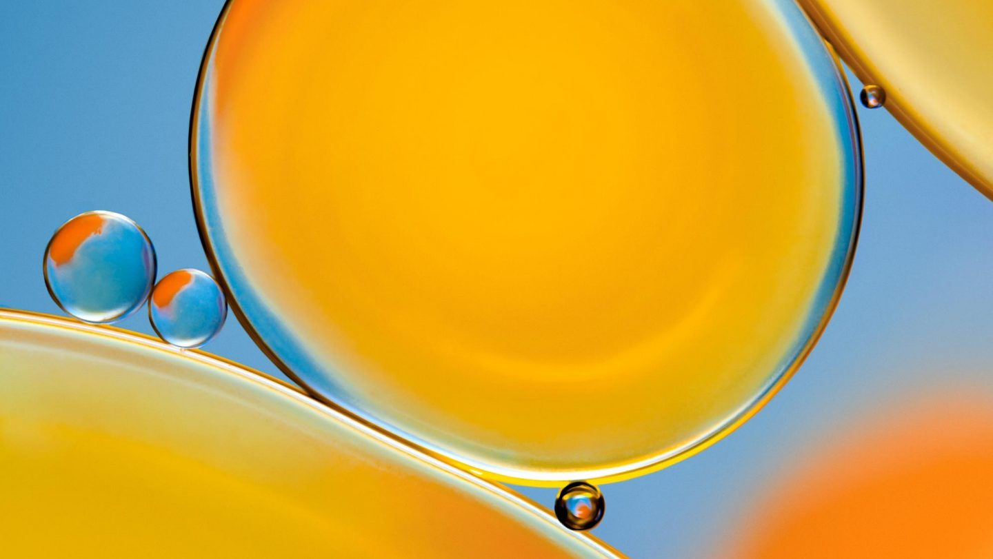 Vibrant and colourful abstract macro image of oil drops floating on water