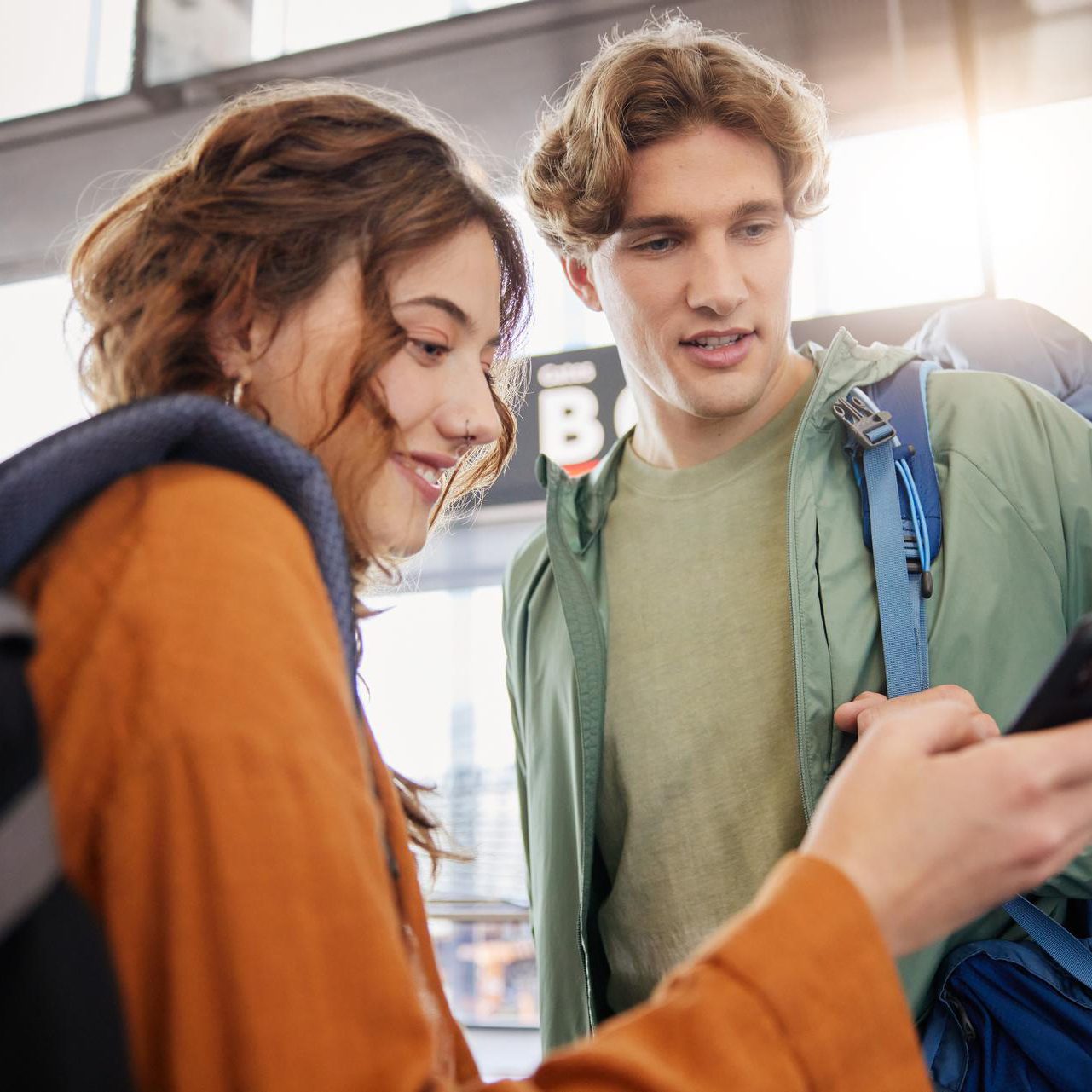 Two students at the gate checking their phone.