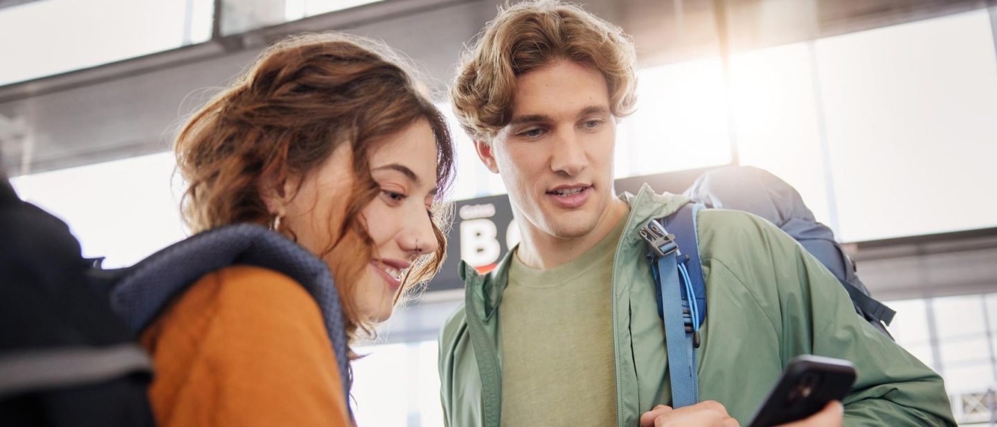 Student booking a flight via a smartphone app.