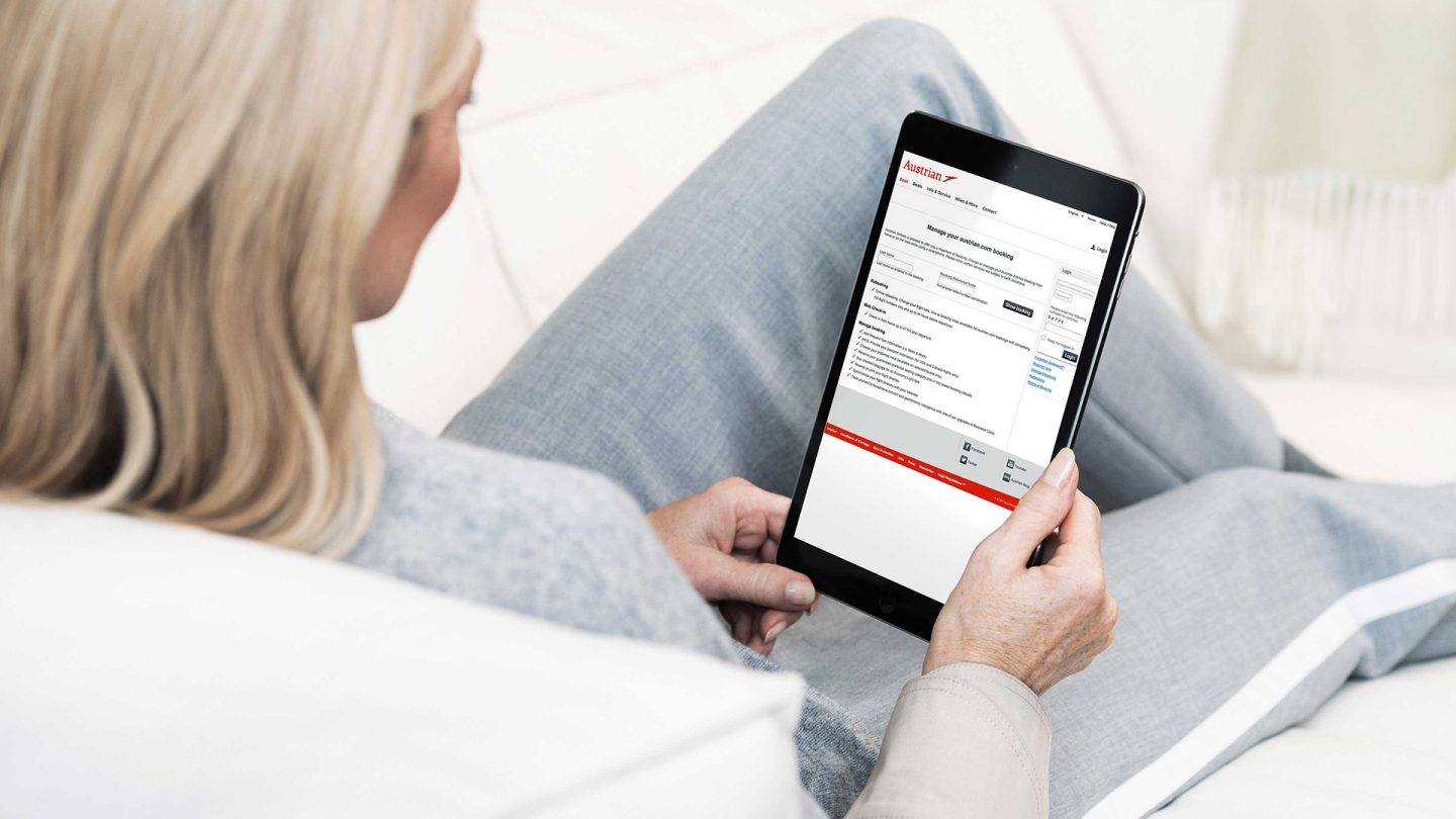 A woman using the Austrian My Bookings website on her tablet