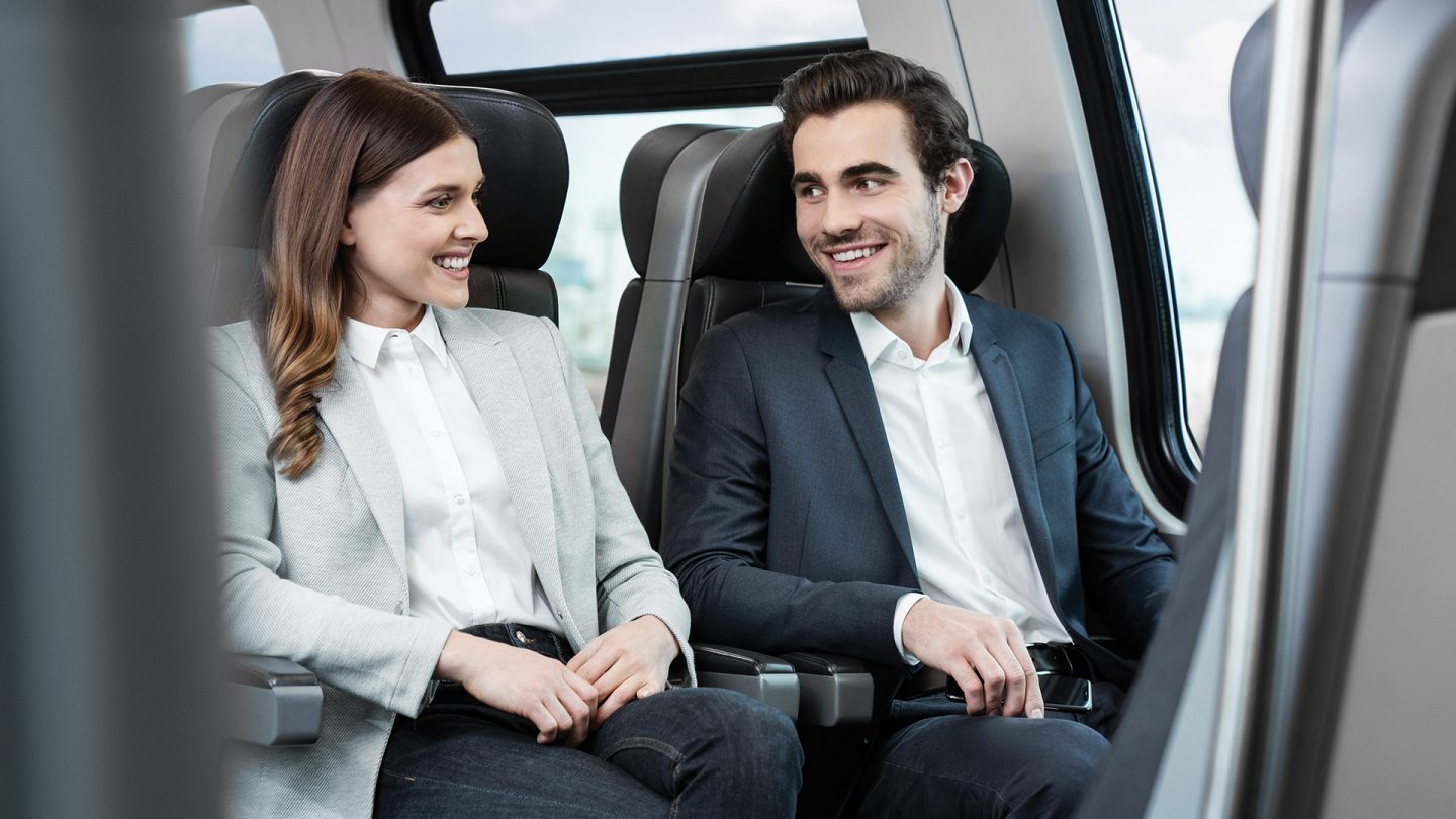 A young couple takes the train to the airport