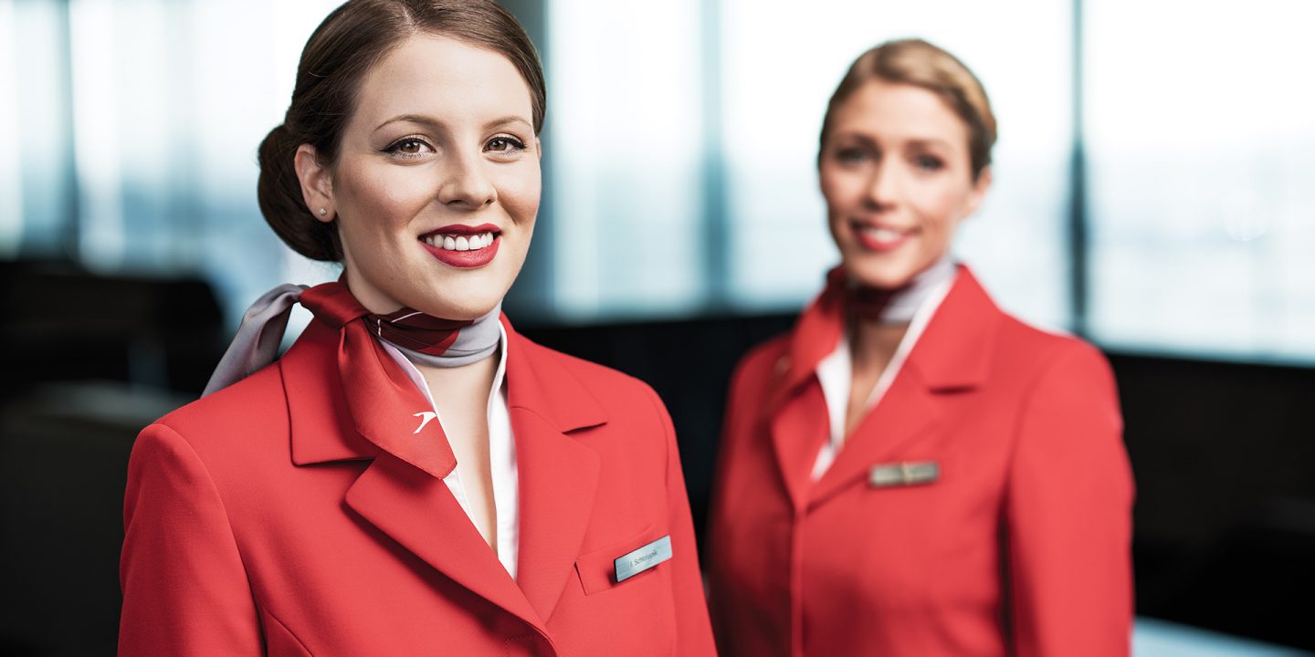 Two Austrian Airlines employees at the airport in their uniforms