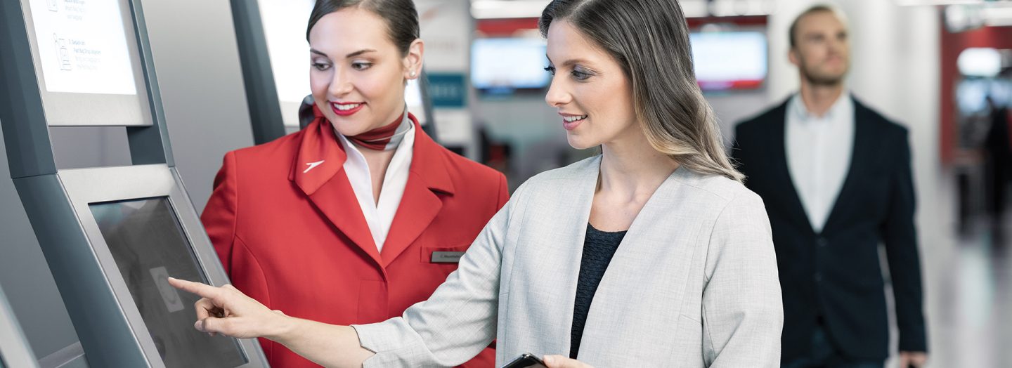 Austrian staff helps women at the airport terminal