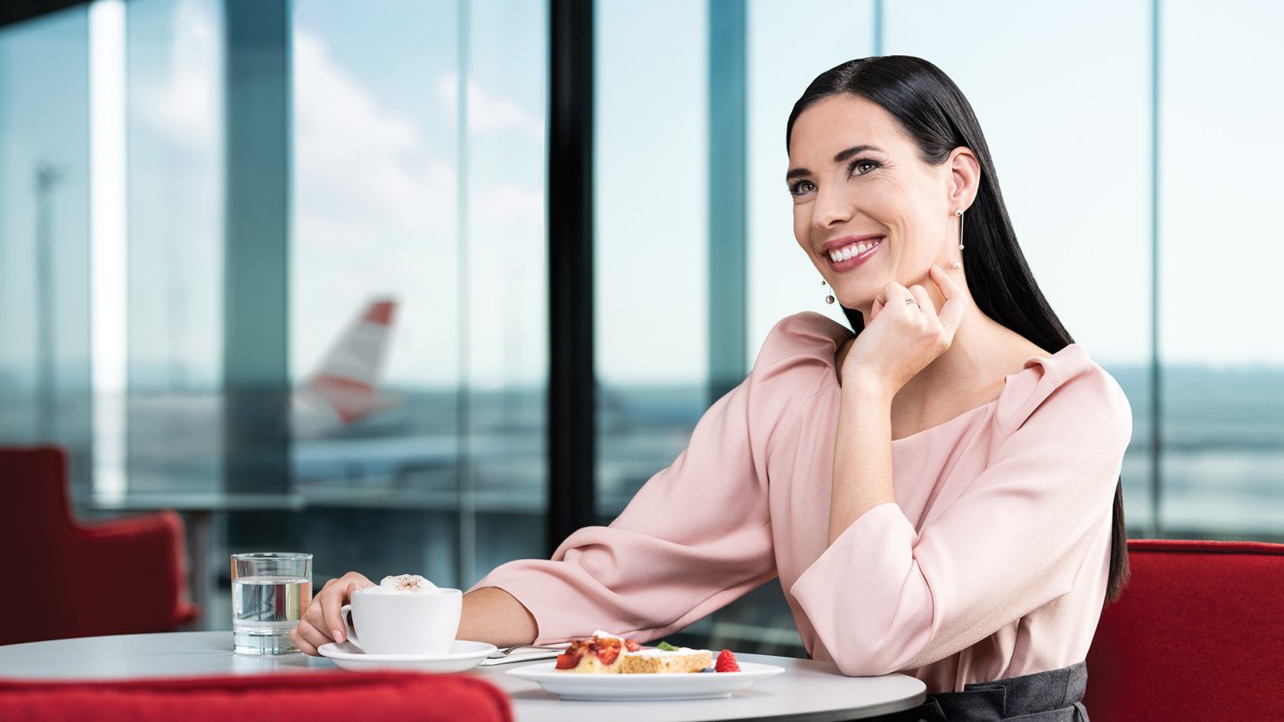 Businesswoman enjoys coffee and cake in an Austrian lounge