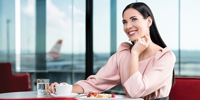 Businesswoman enjoys coffee and cake in an Austrian lounge