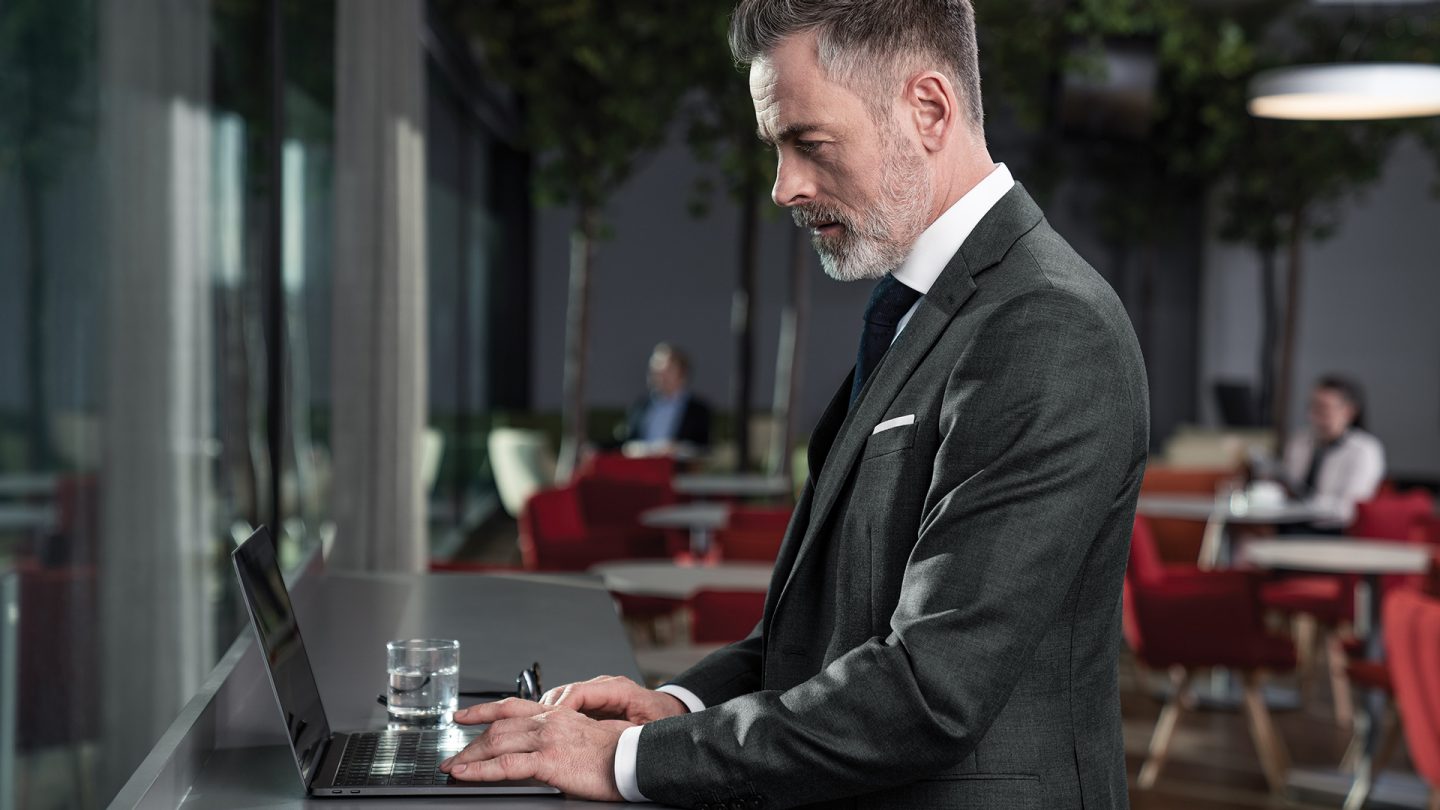 Businessman using laptop in Austrian lounge
