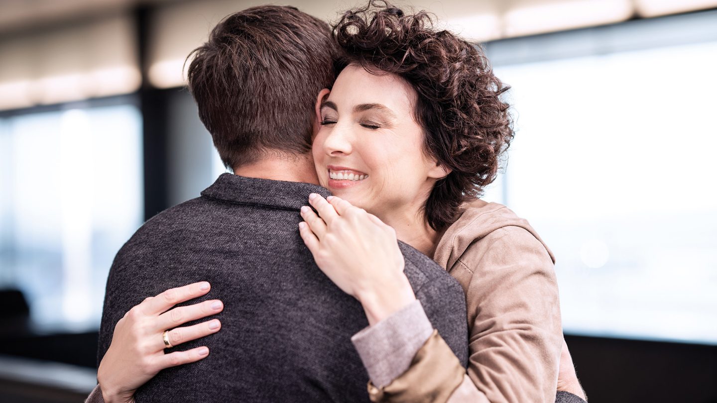 Two passengers hug each other