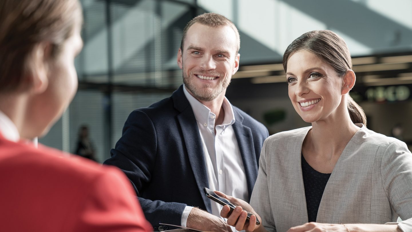 A couple of passangers in a dialog with an Austrian employee