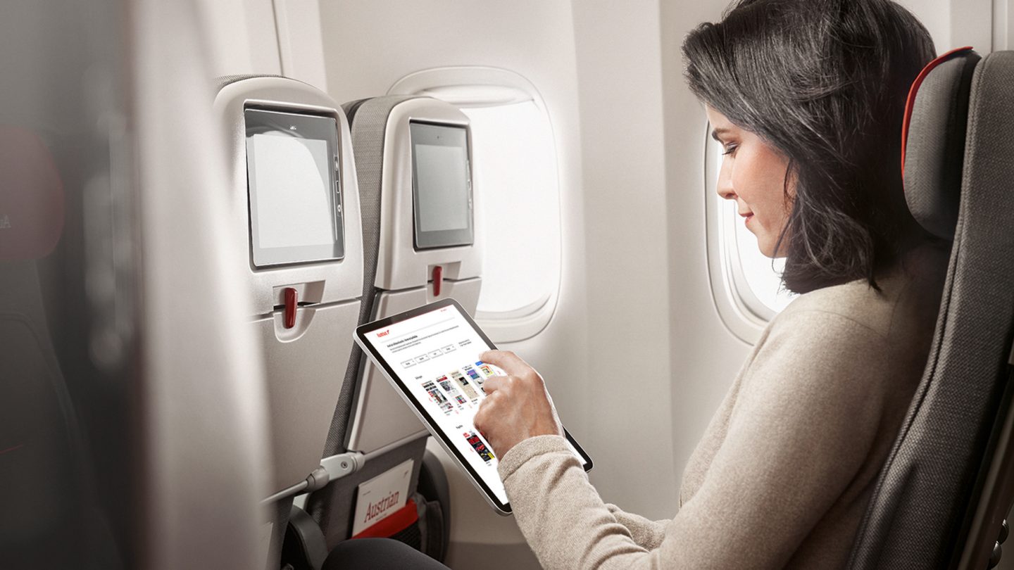A woman chooses eJournals on the tablet
