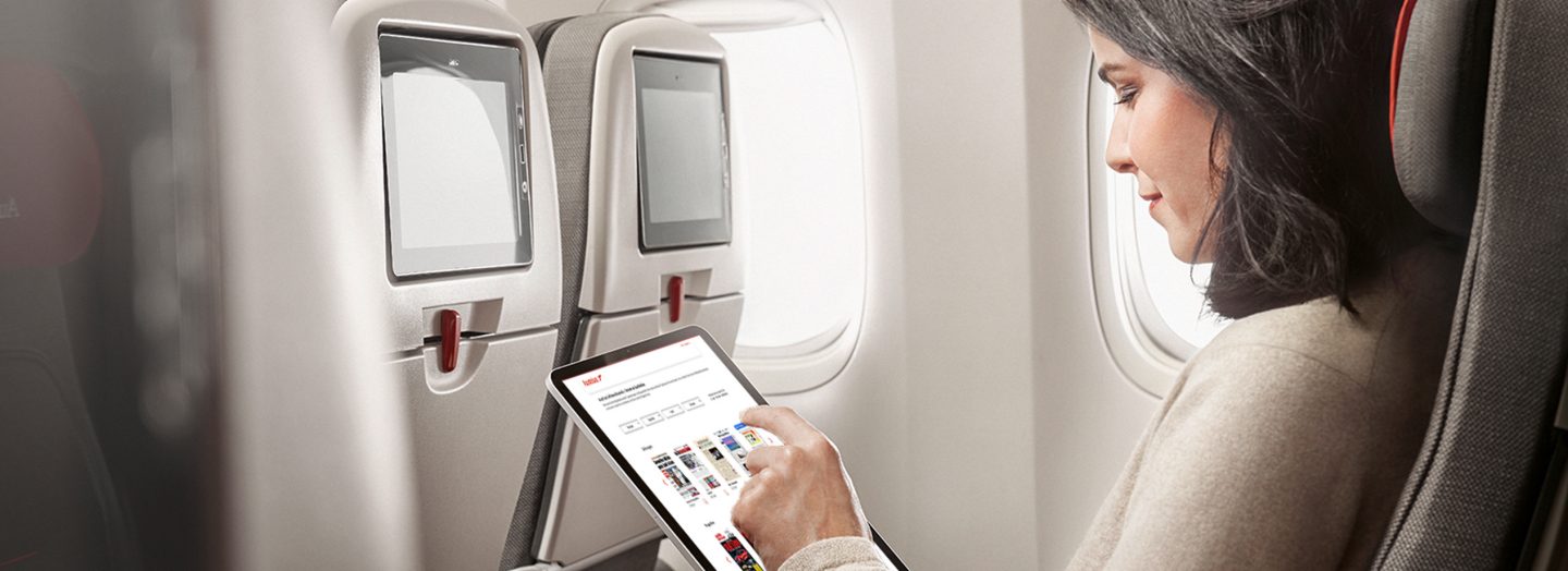 A woman chooses eJournals on the tablet
