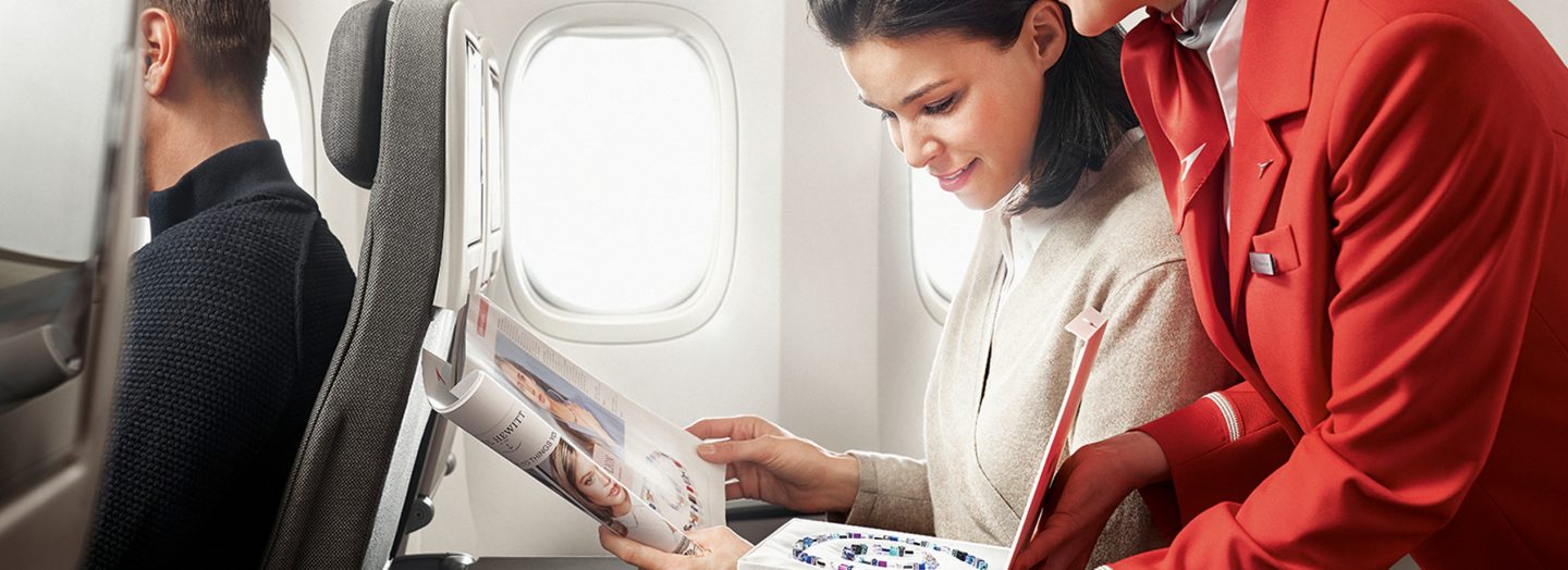 A flight attendant presents the jewelry from the Austrian shopping catalog