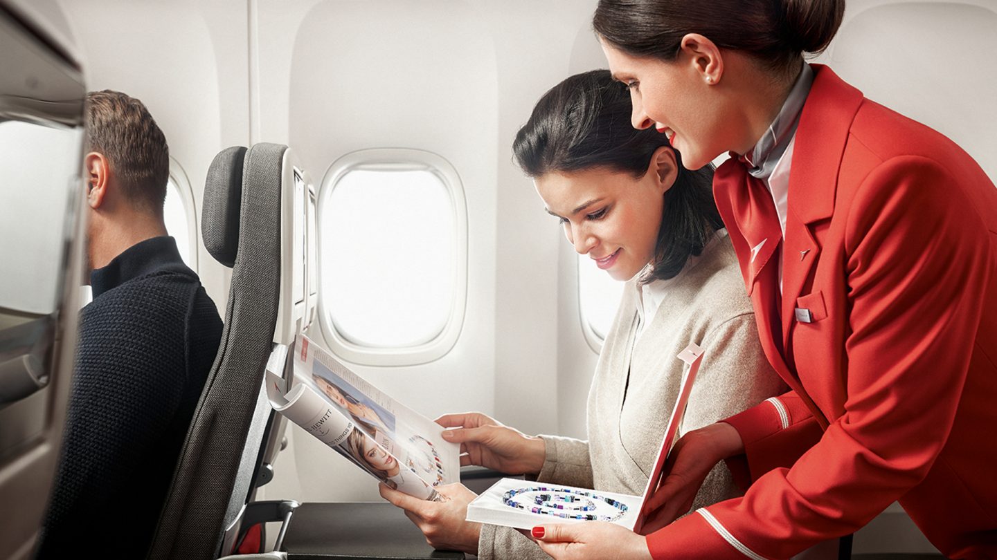 A flight attendant presents the jewelry from the Austrian shopping catalog
