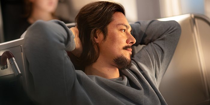 Young man sits relaxed on the plane