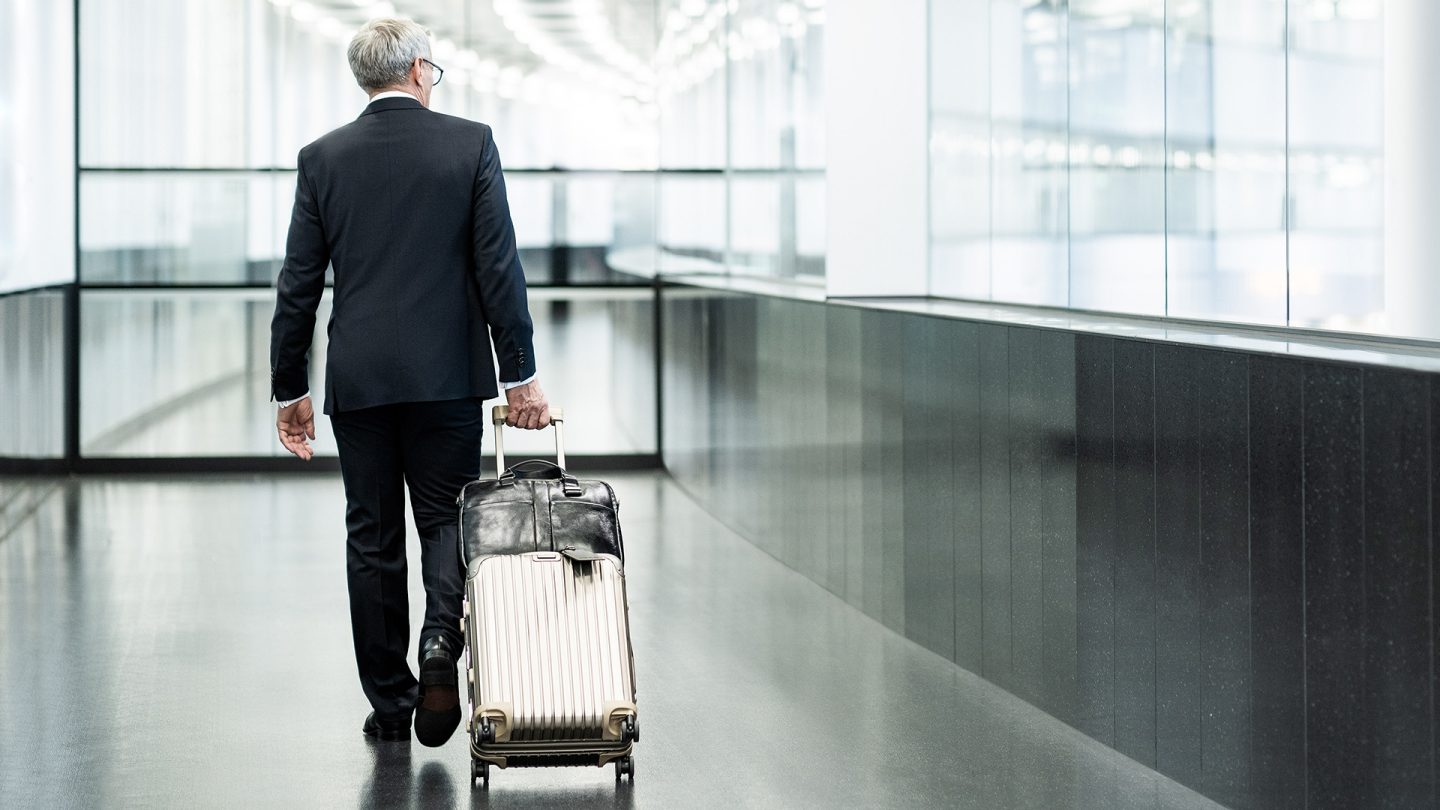 A business class traveler pulls his luggage